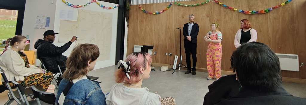 Audience members watching the opening ceremony in 2024.