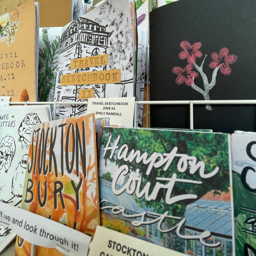 A shelf of zines and notebooks for sale.