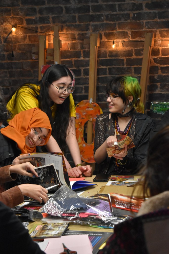 A group of students enjoying themselves at a zine-making workshop.